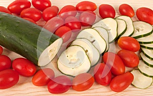 Slices of cucumbers and tomatoes .