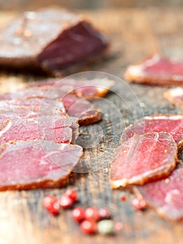 Slices of cured meet and pepper vertical