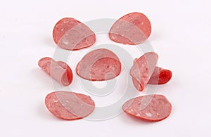 Slices of deli ham, mortadella, salami on white background