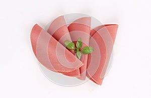 Slices of deli ham, mortadella, salami on white background
