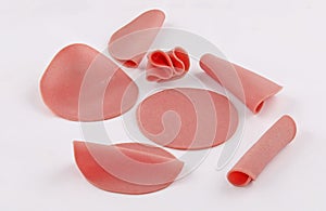 Slices of deli ham, mortadella, salami on white background