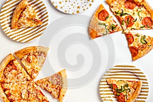 Slices of delicious fresh pizza with pepperoni and cheese on a white plate. Birthday with junk food. Top view with copy