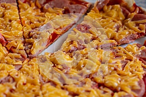 slices of delicious pizza with sausage and cheese closeup as background