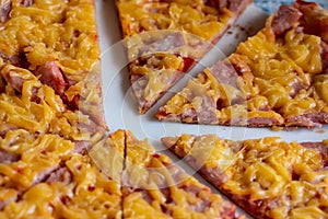 slices of delicious pizza with sausage and cheese closeup as background