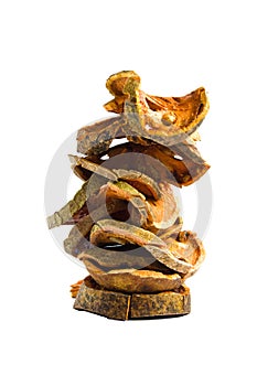 Slices of dried bael fruit on white background