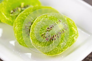 Slices of dried kiwi fruit on a white plate