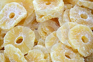 Slices of dried pineapple in sugar syrup.