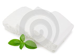 Slices feta cheese with basil isolated on white background. Clipping path and full depth of field