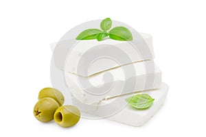 Slices feta cheese with olives and basil isolated on white background. Clipping path and full depth of field