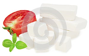 Slices feta cheese with tomato and basil isolated on white background. Clipping path and full depth of field
