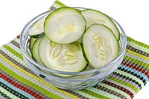 Slices of fresh cucumber in glass bowl