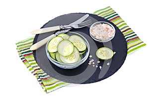 Slices of fresh cucumber in glass bowl.