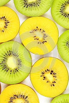 Slices of fresh green and yellow kiwi fruits food background texture