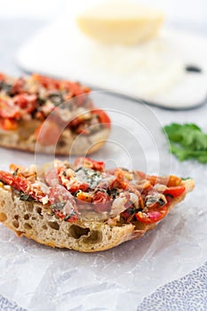 Slices of fresh homemade bruschetta on a white