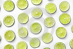 Slices of fresh juicy limes on white background