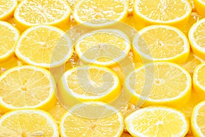 A slices of fresh juicy yellow lemons. Texture background, patt