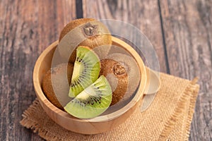 slices of fresh kiwi in a wood bowl