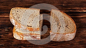Slices of fresh and stale bread on a dark wooden background_