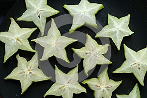 Slices of fresh star fruit. Carambola on black background.Healthy food.