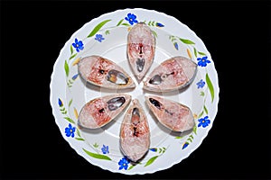 Slices of fresh tenualosa ilisha or hilsa fish in a ceramic plate