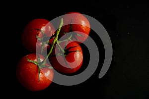 Slices of fresh tomatoes on black background