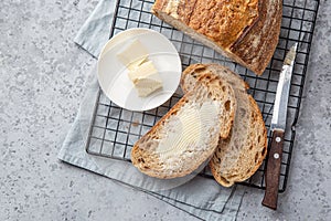 Slices of freshly baked homemade sour dough bread with butter