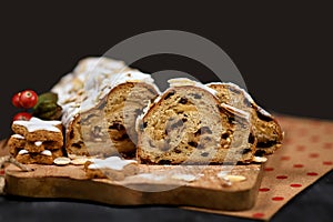 Slices of German Stollen cake, a fruit bread with nuts, spices, and dried or candied fruits, coated with powdered sugar