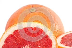 Slices of grapefruit macro closeup on white background