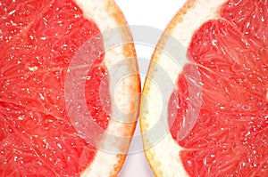 Slices of grapefruit macro closeup on white background