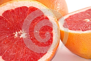 Slices of grapefruit macro closeup on white background