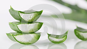 Slices of green Aloe Vera leaves on white background selective focus