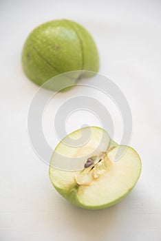 Slices of green healthy apple fruits on a white background