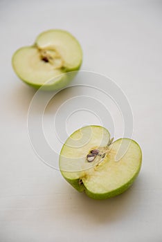 Slices of green healthy apple fruits on a white background