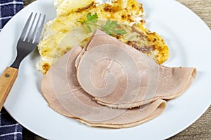 Slices of ham and potato gratin