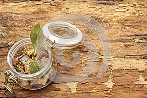 Slices of herring with spices in a glass jar