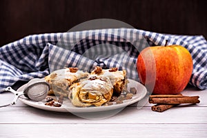 Slices of homemade Apple pie strudel in a plate on a wooden table