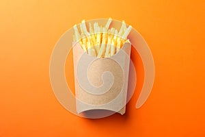 Slices of hot french fries in box on background, space for text. Top view