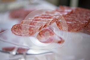 Slices of Italian salami on a glass plate