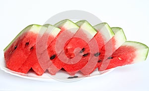 Slices of juicy watermelon served on white plate