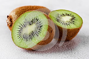 Slices of kiwi fruit on kiwi background.Fresh kiwis on wooden ground
