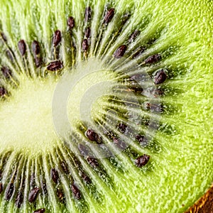 Slices of kiwi fruit on kiwi background.Fresh kiwis on wooden ground