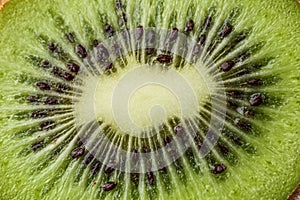 Slices of kiwi fruit on kiwi background.Fresh kiwis on wooden ground