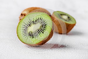 Slices of kiwi fruit on kiwi background.Fresh kiwis on wooden ground