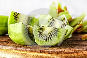 Slices of kiwi fruit on kiwi background.Fresh kiwis on wooden ground