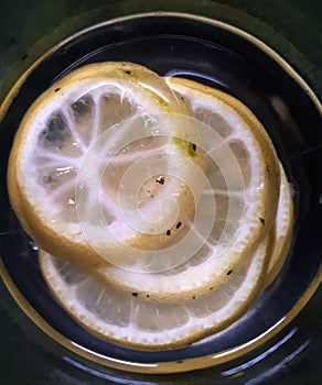 Slices of lemon floating in warm water