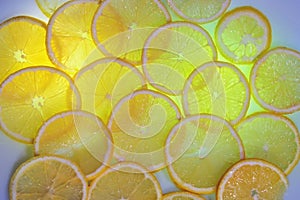 Slices of lemon fruit coloring with yellow and green backlights