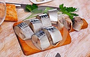 Slices of lightly salted mackerel fish served with greens