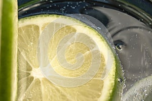 Slices of lime in a glass of soda water