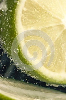 Slices of lime in a glass of soda water