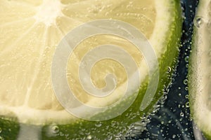 Slices of lime in a glass of soda water